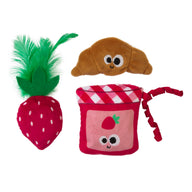 The Mad Cat Kitty Croissant 3 Pack™ by Mad Cat includes three plush toys: a strawberry with green feathers, a smiling croissant, and a pink jam jar with strawberry prints. Each vibrant, catnip-infused toy features playful expressions to entertain your feline friend.