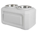 The Vittles Vault Elevated Storage Dog Feeder by Vittles Vault features a modern white plastic stand and two stainless steel bowls, providing optimal comfort for pets while maintaining fresh food storage.