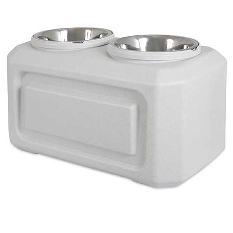 The Vittles Vault Elevated Storage Dog Feeder by Vittles Vault features a modern white plastic stand and two stainless steel bowls, providing optimal comfort for pets while maintaining fresh food storage.