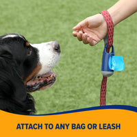 A big tricolored dog on grass eyes a hand with a red leash attached to an Arm & Hammer Dispenser & Disposable Waste Bag Set. Text below reads, Attach to any bag or leash.