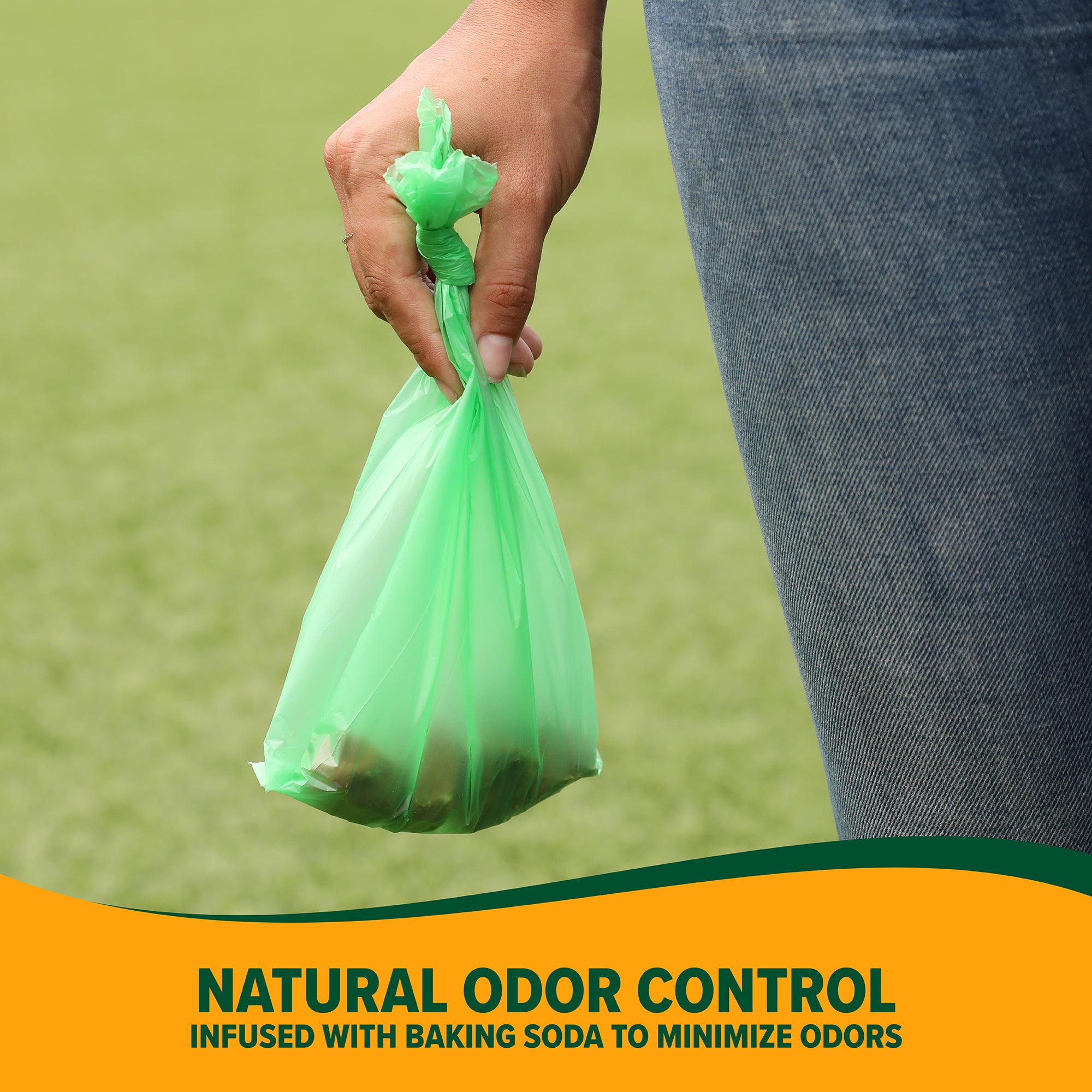 A person holds a green bag filled with pet waste. The text reads: Arm & Hammer Cornstarch Waste Bags infused with Baking Soda for Natural Odor Control. A grassy background highlights these essential Arm And Hammer pet supplies.