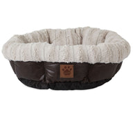 Introducing the SnooZZy Rustic Luxury Ultra Cuddler Pet Bed: a round, plush haven with a soft light gray rim and dark brown base. Its cozy texture offers rustic luxury for your pet, featuring a small paw print logo on the front and a non-skid bottom for stability.