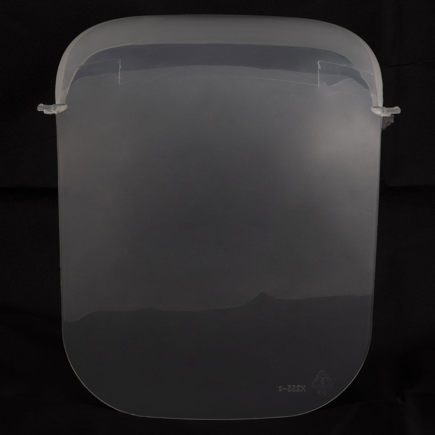 A large, transparent face shield against a dark background resembles the Large Hooded Litter Pan Replacement Door by Petmate, with its rounded edges and small plastic clips ideal for attaching to headgear.