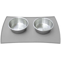 The PetFusion Pet Food Mat in Premium Silicone by Petfusion holds two stainless steel bowls on a gray, FDA-grade waterproof mat with anti-slip bumps to keep them steady.