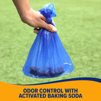 A hand holds a small, tied blue waste bag over grass with Odor Control with Activated Baking Soda on a vibrant yellow and blue backdrop. Ideal for use with your Arm & Hammer Bone Dispenser.