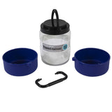 The Vittles Vault Travel-Trainer is a BPA-free pet travel container set featuring a clear cylindrical holder, two blue bowls, a black carabiner, and an airtight seal with a black lid and handle.