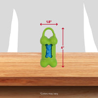 The Arm & Hammer Bone Dispenser & Disposable Waste Bag Set, designed in green and shaped like a bone, measures 1.8 wide by 4 tall with a blue bag roll that controls odors. It features a top clip and is displayed on wood against a gray backdrop. Note: Colors may vary.