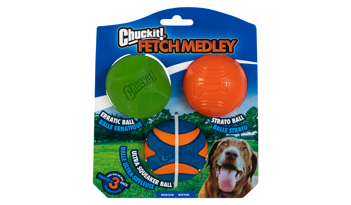 The Chuckit! Fetch Medley 2 by Chuckit features vibrant natural rubber dog toys: a green erratic ball, orange strato ball, and blue ultra squeaker ball. The packaging is complemented by an image of a happy dog playing on grass.