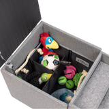 The PetFusion Multi-Purpose Pet Stairs, by Pet Fusion, serve as a premium gray storage ottoman filled with colorful pet toys like a plush parrot and soccer ball. Its thoughtfully sectioned interior offers an organized, multi-functional solution for play and tidy living.